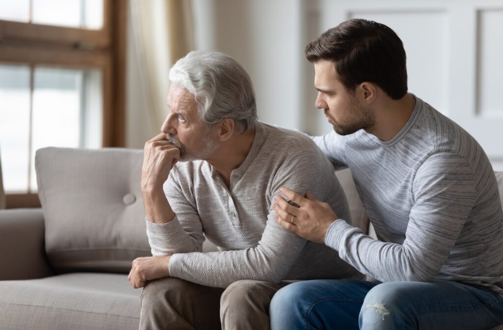 A man talking to his hesitant senior father about the idea of moving into a memory care community
