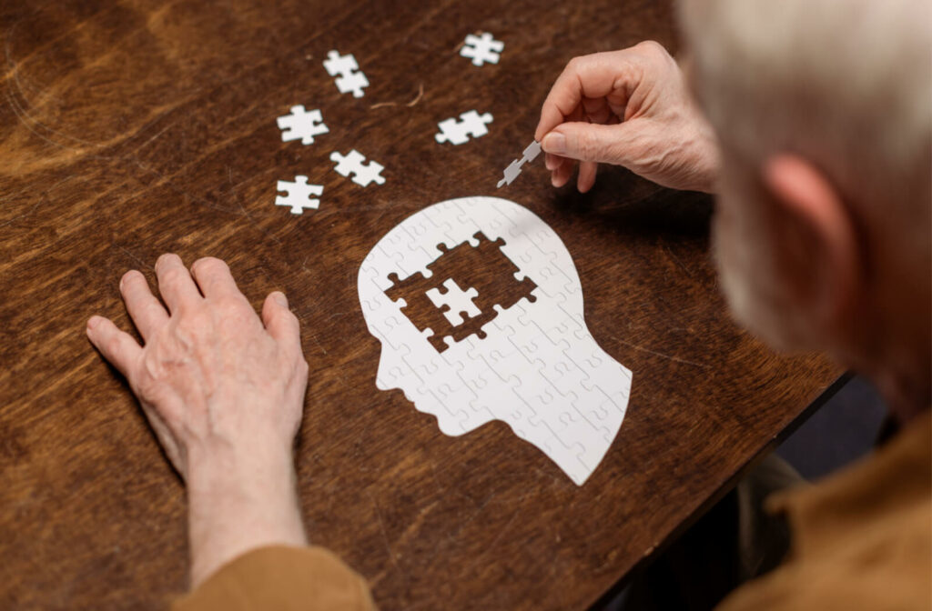 a puzzle shaped like a head with piece in the centre missing to represent dementia